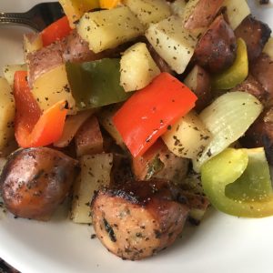 2 lbs. link pork sausage, sliced 5 lbs. red potatoes, diced 1 onion, diced 1 red bell pepper, diced 1 green bell pepper, diced 1-2 Tbs. Montreal Steak Seasoning 1 tsp. dried or fresh parsley 1 tsp. dried basil 1 tsp. garlic powder 1 tsp. salt 1/4-1/2 cup Kraft Sundried Tomato Salad Dressing Directions Preheat the oven to 420 degrees. RInse all of the potatoes and cut off any bad spots. Cut the potatoes into small, diced pieces. Place these on a cookie sheet. Slice the onions into large pieces and place on the cookie sheet. Slice the sausage into one inch thick slices and place on top of the potatoes and onions. Season the entire pan with Montreal Steak Seasoning, garlic powder, basil, salt and parsley. Place the pan in the oven (uncovered) and bake for 25-30 minutes, or until potatoes are tender. For the last 10 minutes of the cooking time, place the peppers on top of all of the items. Bake until the peppers are tender and then serve. If you want a little extra flavor, the salad dressing is good to eat with the potatoes and peppers. Additional Information *Make sure you buy a good quality sausage because all of the vegetables will take on some of the flavor of the sausage. Costco sells a really delicious link sausage (chicken or pork) that tastes amazing in this recipe! If you don't buy Costco's sausage, just make sure you buy a good quality sausage so the dish will taste great.